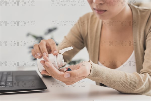 Close up woman taking pills office