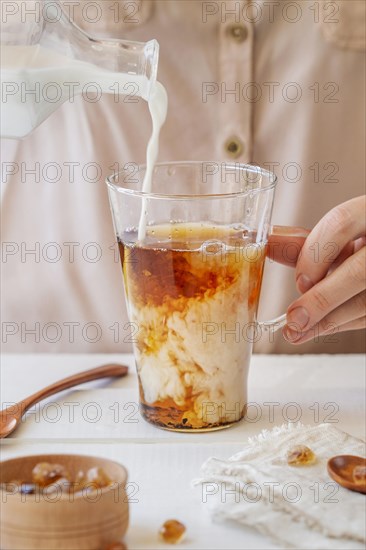 Front view woman preparing milk tea