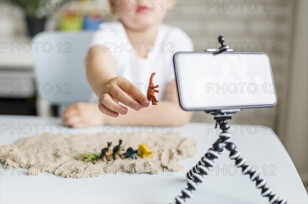 Close up kid holding dinosaur