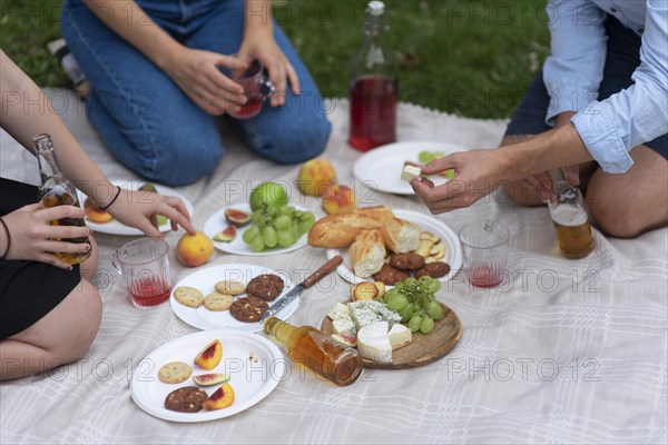 Close up friends eating picnic