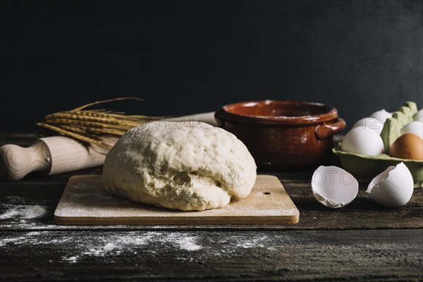 Knead dough with ingredients wooden table