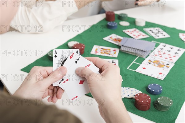 Close up person playing poker