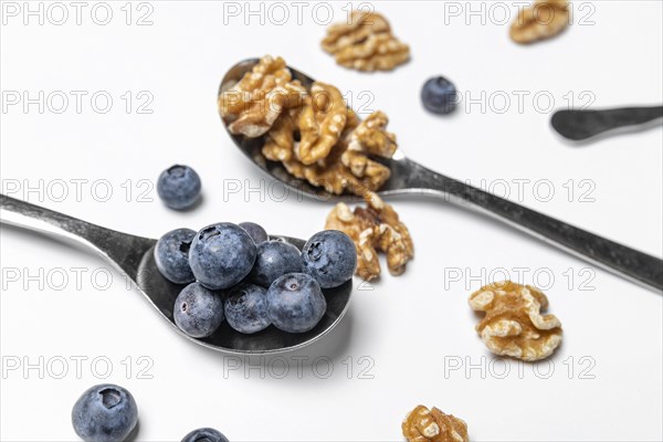 High angle blueberries walnuts spoons