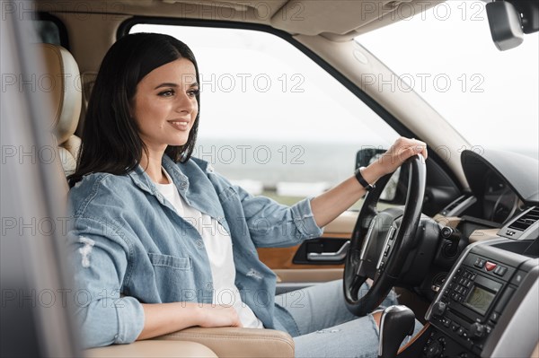 Side view smiley woman traveling alone by car