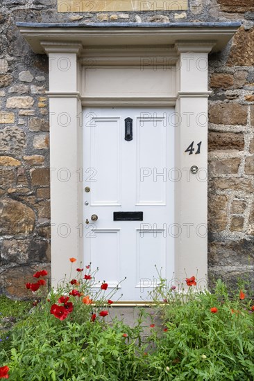 White front door on an old stone house