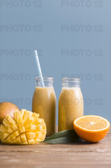 Front view smoothie bottles with mango orange