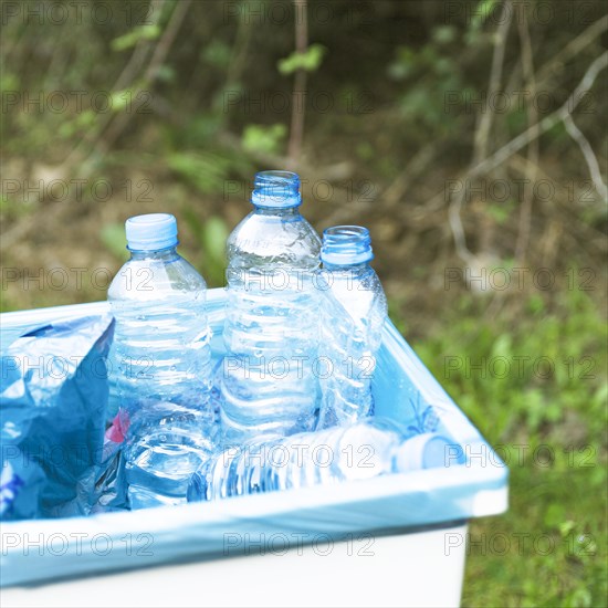 Trashcan with plastic garbage outdoors