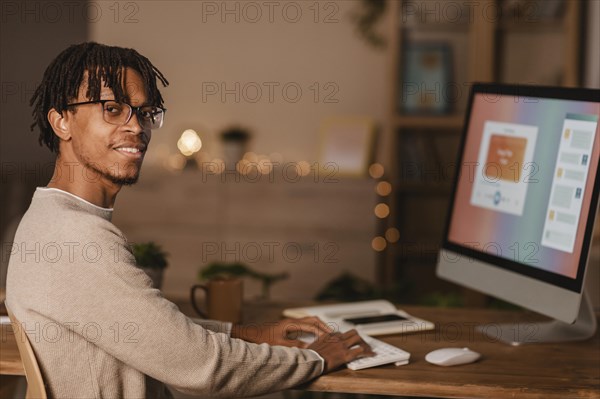 Side view man using personal computer home