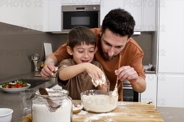 Father kid cooking together