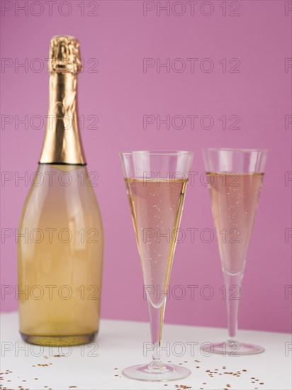 Champagne bottle with filled glasses