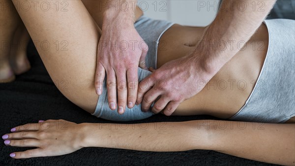 Male physiotherapist woman during massage session