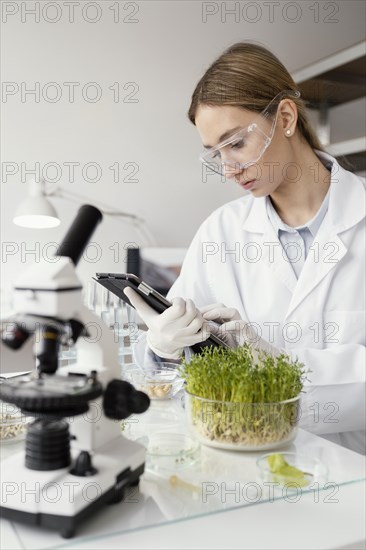 Medium shot scientist working lab