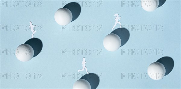 Top view paper athletes with ping pong balls