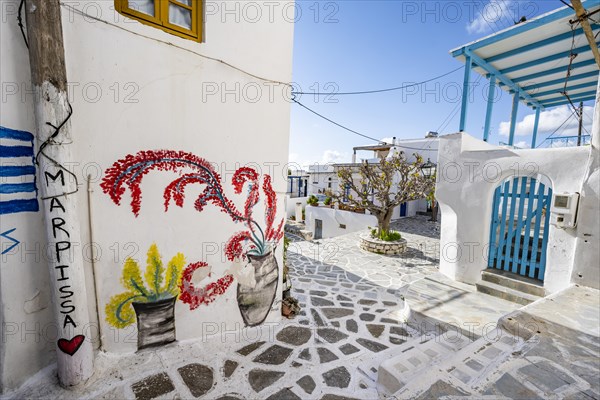 Painted house wall with inscription Marpissa and flowers