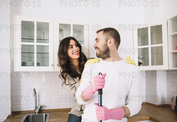 Couple embracing while cleaning