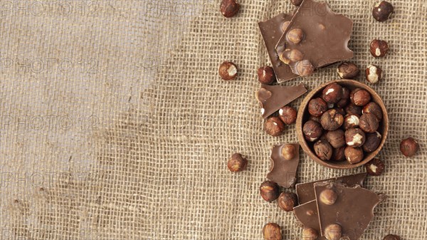 Top view chocolate with hazelnuts burlap copy space