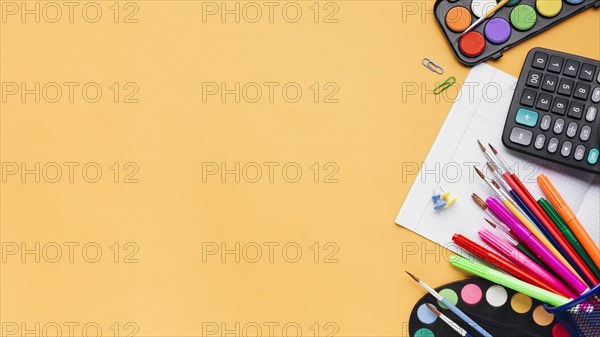 Multicoloured stationery calculator beige background