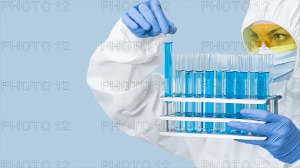 Scientist looking blue chemicals