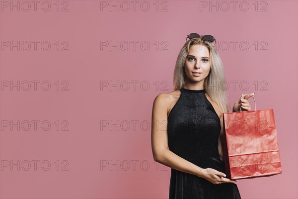 Woman showing red paper bag