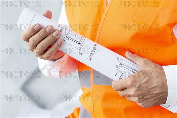 Architect holding plans close up