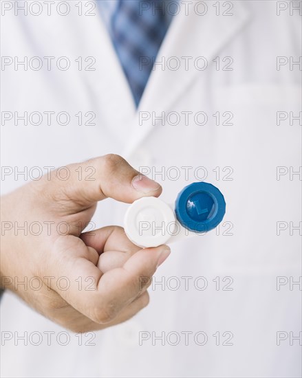 Doctor with holding pair contact lenses