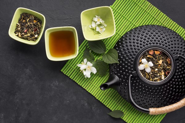 Dried tea herb with white jasmine flower textured background