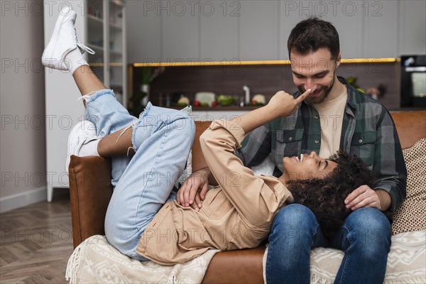 Happy young couple playing sofa