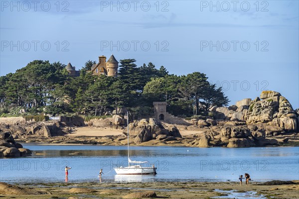 The rocks of the pink granite coast Cote de Granit Rose near Ploumanac'h and Costaeres Castle