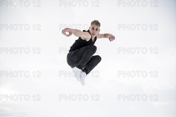 Male dancer posing while mid air