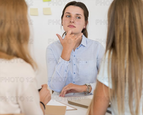 Woman teaching sign language other people