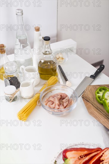 Ingredients making spaghetti white table