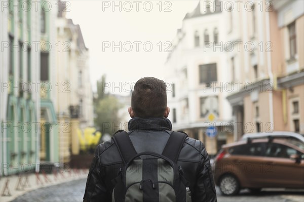 Man with backpack old street