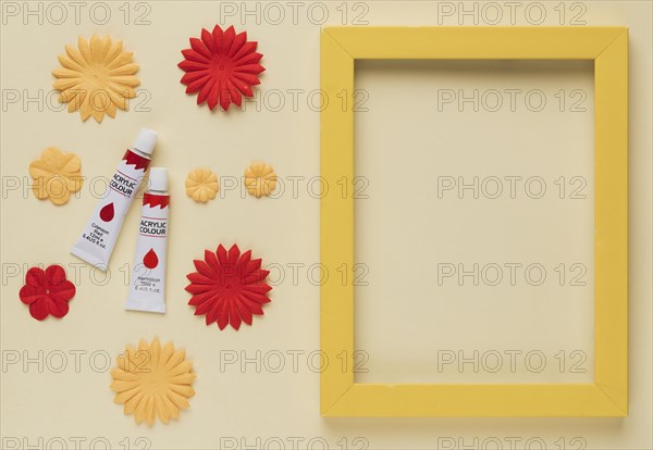 Paint tube flower cutout yellow wooden frame border beige background