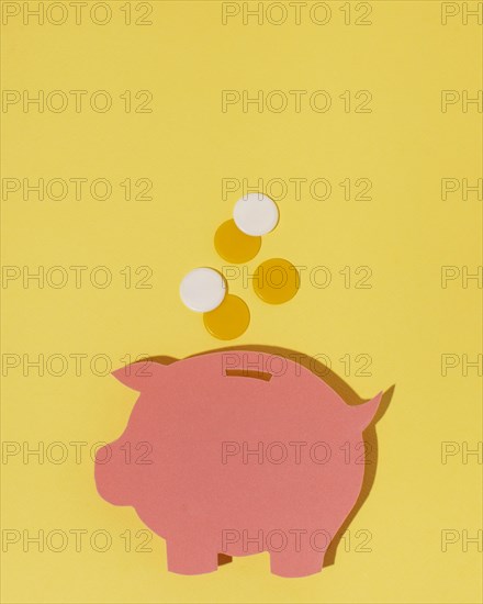 Top view piggy bank yellow background