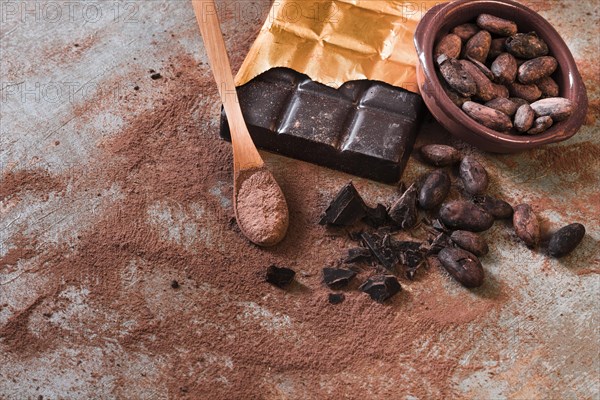 Crushed broken chocolate cocoa beans bowl rustic backdrop