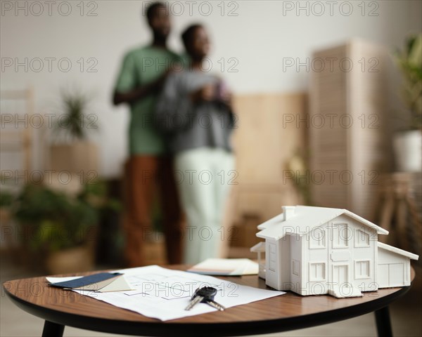 New home keys plan table with defocused couple