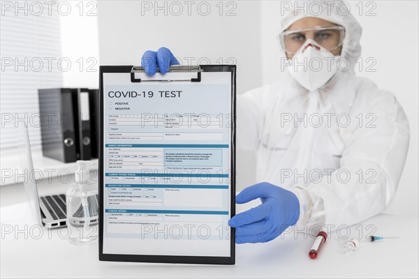 Doctor holding covid test form