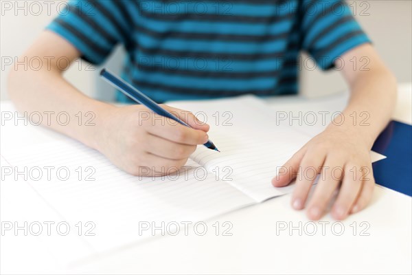 Kid writing empty notebook