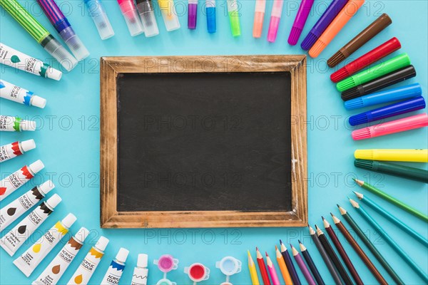 Top view blackboard surrounded by painting elements