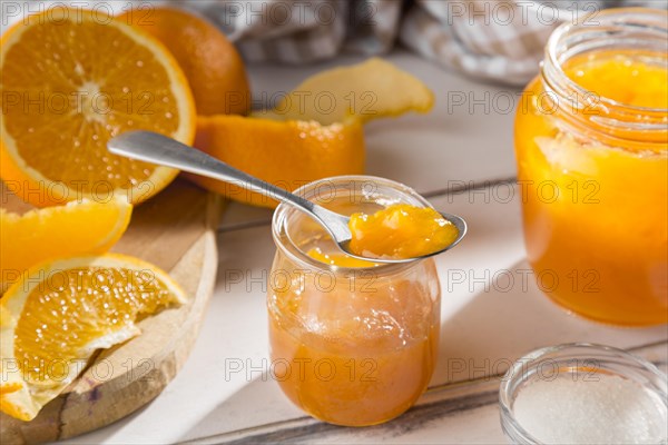 High angle clear glass jar with orange jam
