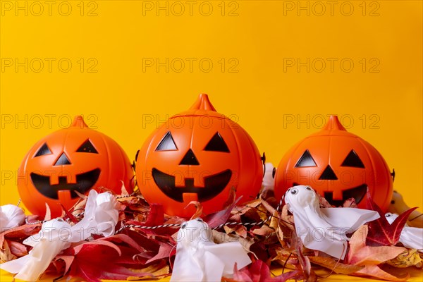 Halloween orange pumpkins on a background of yellow