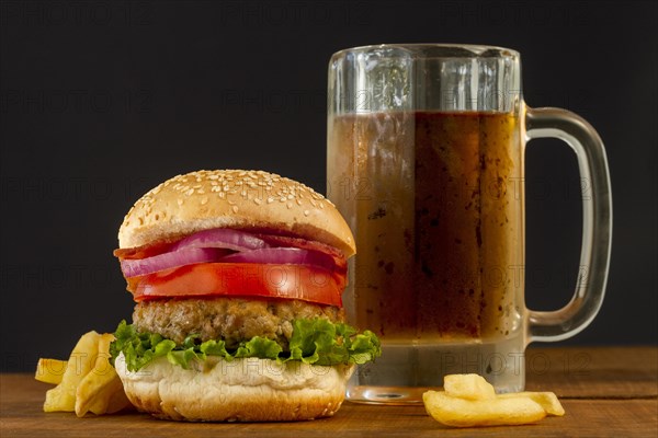 Fresh hamburger with fries beer mug