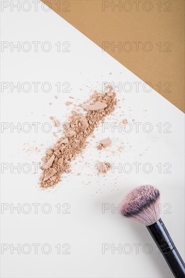 Overhead view face powder brush dual colored background