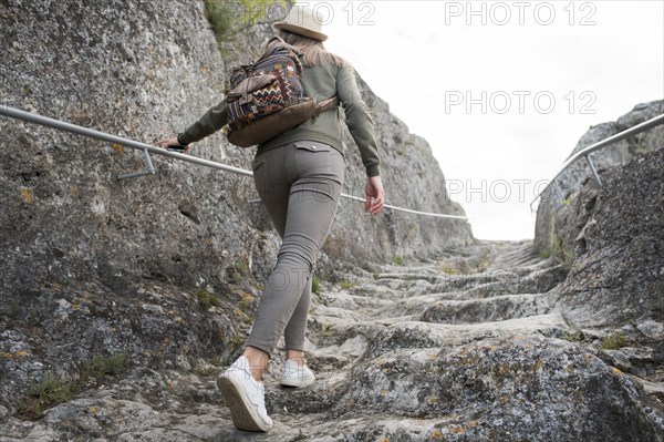 Back view traveller climbing stairs