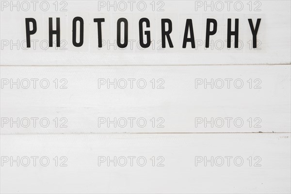 Elevated view graphy text white wooden table