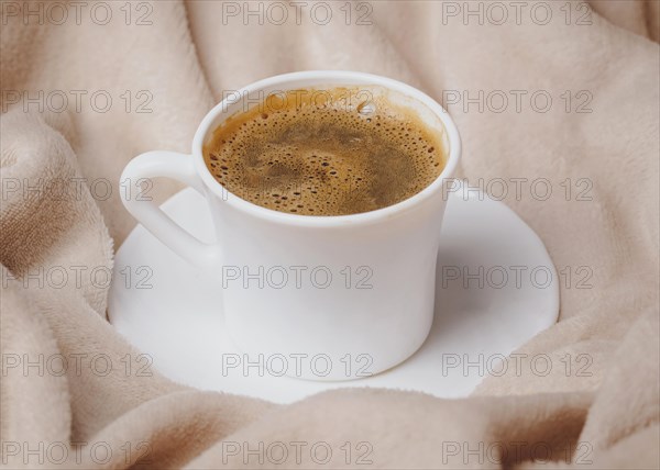 High angle morning coffee cup bed