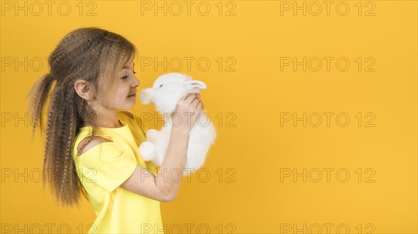Cute girl looking white rabbit
