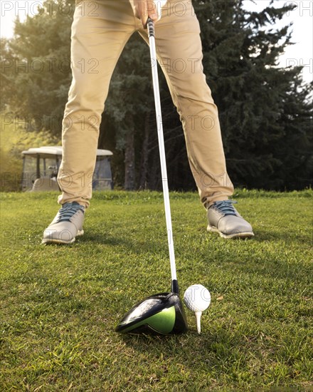 Front view man practicing golf field