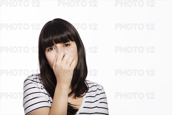 Woman covering nose