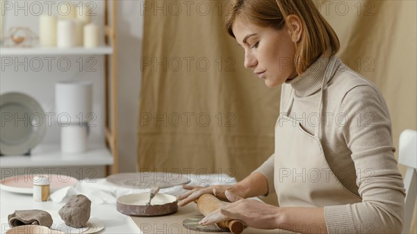 Close up woman working with rolling pin